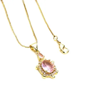 Detail of a turtle pendant with pink crystals and micro-pave stones on a gold box chain