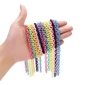 Detailed macro view of colorful 6x8mm acrylic chain links held in hand for DIY jewelry making