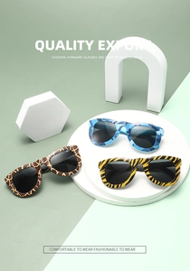 Kids camouflage and animal print party glasses displayed on geometric display props