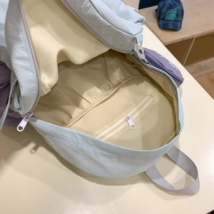 Modern casual canvas backpack interior with cream lining and a secure zipper pocket