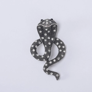Detailed view of silver-black cobra brooch featuring crystal scales and gem eyes