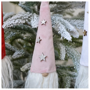 Detail of Christmas Swedish Tomte gnome hangers with sequins and faux fur on snowy branches
