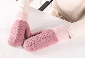 Detailed view of pink knitted mittens featuring cable stitch and soft faux fur cuffs