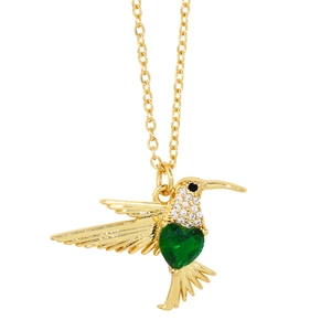 Elegant gold hummingbird necklace with green heart zircon and pave crystals on white background