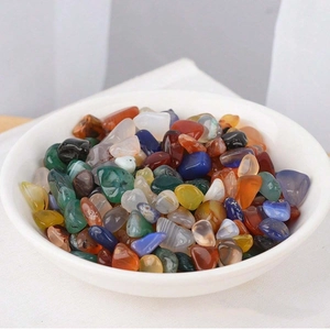 Assorted polished natural crystal stones in a white ceramic bowl for home decoration