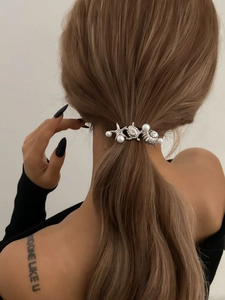 Silver ponytail cuff featuring starfish, seashell and pearl charms on model's hair