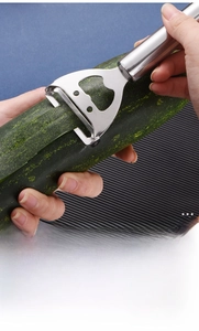 Macro detail of stainless steel fruit peeler with integrated bottle opener tool