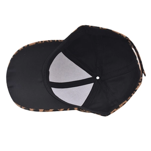 Detail view of leopard print baseball cap interior featuring black fabric lining and support