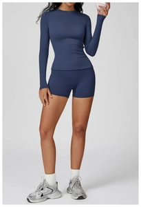 Slim fit navy yoga top and high-waist shorts showing moisture-wicking fabric texture