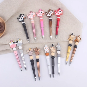 Detailed top view of 12 creative cartoon cow silicone bead pens in various metallic colors