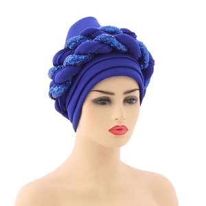 Close-up of royal blue turban hat featuring shiny sequin braided decorative band