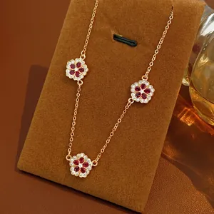 Elegant 18K gold plated flower necklace with three red zircon floral pendants on a thin chain