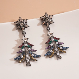 Macro detail of Christmas tree earrings with colorful crystals and pearl accents
