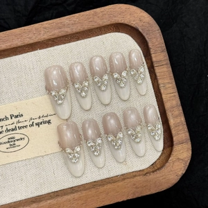 Handmade press-on nails with cat-eye heart gems and French butterfly crystal design