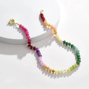 Detailed macro view of bohemian colorful gradient stone beaded necklace with gold clasp