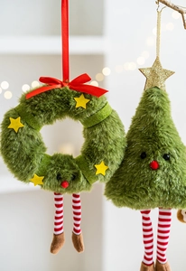 Close-up of plush Christmas wreath and tree ornaments with red striped long legs