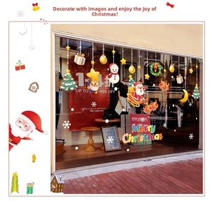 Close-up of Santa Claus and reindeer Christmas window stickers on glass shopfront