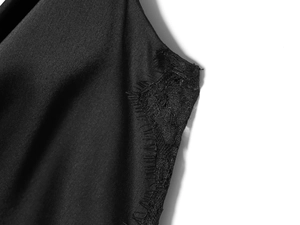 Detail of black satin fabric featuring exquisite eyelash lace trim on a women's dress