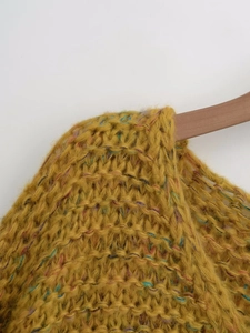 Detail of ginger yellow chunky knit sweater featuring multi-color speckled wool texture
