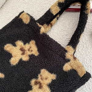 Close-up of teddy bear plush tote bag showing soft sherpa fleece fabric texture