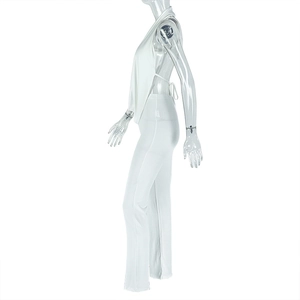 Side view of white halter neck backless top and matching trousers set on a clear mannequin