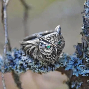Vintage silver 3D owl ring with green gemstone eyes on a mystic forest branch