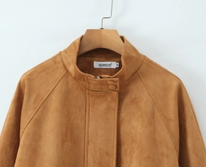 Close-up of stand collar with buckle on tan suede jacket showing soft fabric texture