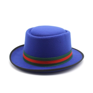 Detail of navy wool felt pork pie hat featuring signature red and green striped band