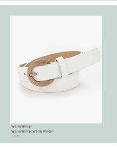 Detailed close-up of white leather belt featuring a classic bronze arched pin buckle