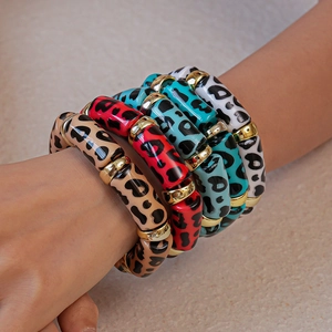 Close-up of leopard print acrylic bamboo bangles in brown red blue and white colors