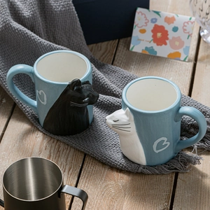 Ceramic matte cat mugs set for couples with heart patterns on a soft scarf background