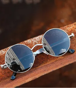 Macro shot of silver steampunk sunglasses featuring metal spring hinges on rusty steel beam