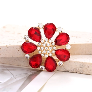 Detailed close-up of a red teardrop crystal flower shoe charm with a golden alloy base