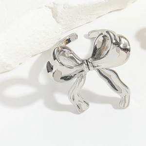 Macro detail of silver bow ring on stone surface with elegant metallic highlights