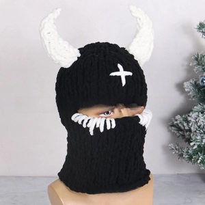 Detail of knitted balaclava with white devil horns and cross pattern on black fabric