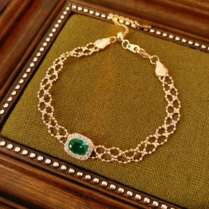Detail of vintage gold bracelet with emerald zircon and adjustable slide closure