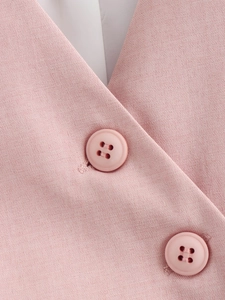 Close-up of pink asymmetric vest showing high-quality fabric and matching buttons