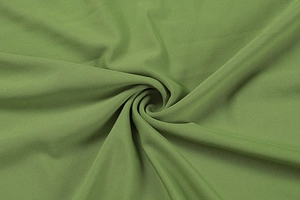 Detailed macro view of olive green ribbed knit fabric texture with soft drapery fold