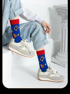 Detail of blue Halloween crew socks with pumpkin and ghost patterns in soft cotton fabric