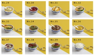 Macro view of realistic PVC food charms in miniature blue and white porcelain style bowls