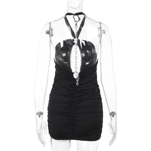 Detail of black halter bodycon dress featuring backless design and metal chain links