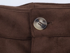 Detailed close-up of marble texture button on dark brown faux suede casual jacket
