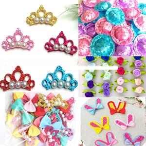 Selection of DIY hair accessories including glitter crowns, silk roses and ribbon bows