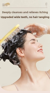 Detail of yellow shampoo brush silicone bristles massaging scalp with thick soap foam
