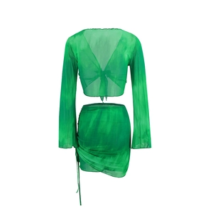Detailed flat lay of green tie-dye mesh two-piece set featuring drawstring mini skirt