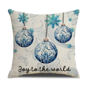 Detail of Christmas pillow cover with blue ornaments and Joy to the world print