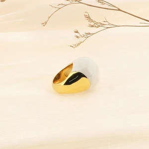 Detailed view of wide 18k gold plated titanium ring with white enamel dome inlay