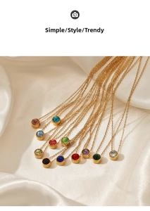 Flat lay of twelve assorted colors crystal pendants on gold stainless steel chains