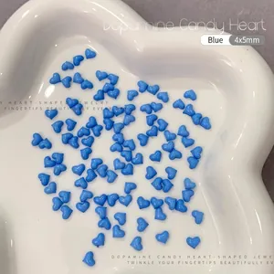 Macro shot of 4x5mm blue resin heart charms for nail art and DIY jewelry crafts