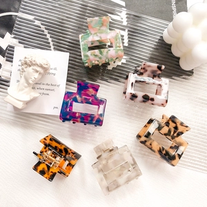 Set of six colorful square acetate hair claws in various marble and tortoiseshell patterns
